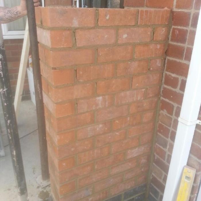 Dryfix Technician and bricklayer Alan is erecting a new wall to support the canopy of a porch as the original supporting timber posts had decayed.&nbsp;