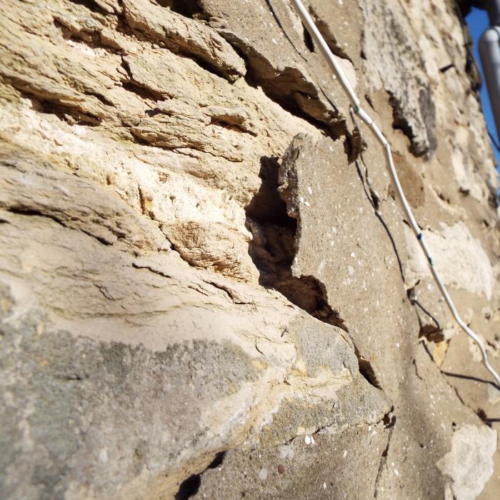 Soft sandstone wall inappropriately pointed with a dense cementitious mortar unfortunately  to the detriment of the stone work.
