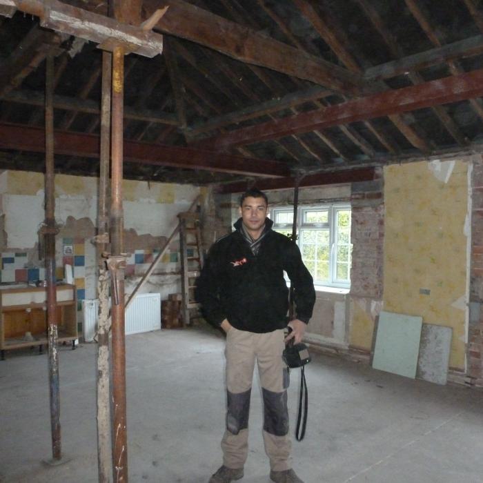 All Steels in situ and our M.D Russell looking very pleased with progress.
A project in Tadcaster where we have removed all the internal dividing walls to create one large &nbsp;Kitchen / Dining room area. The specification is one large room with a vaulted ceiling perimeter and central well to include exposed French Oak beams. The existing fire place in addition to the chimney stacks at roof level will be completely dismantled and rebuilt including a log burning stove. Extensive rebuilding of the walls is required for this project in addition to support of the entire roof structure, wall plate and window openings. Large steel beams weighing in excess of 1 1/2 tonne each will be required to created the vaulted ceiling in addition to new steel work above all the window openings and roof structure . The existing roof structure will have a new roof frame built internally to create the shape of the vault in addition to providing support to the original roof and the whole roof is to be treated against wood boring inspects (woodworm). The entire room is also to be damp proofed and all walls re-plastered, including huge amounts of high specification insulation to be introduced into the roof and ceilings. . See following pictures of progress. &nbsp;All work was completed by the Dryfix Team.&nbsp;
&nbsp;
&nbsp;