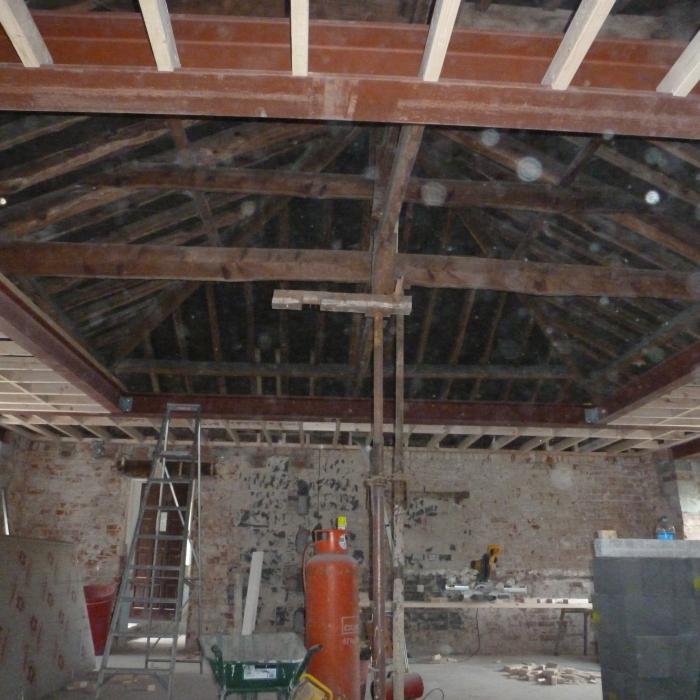Perimeter ceilings being constructed around the new steel work.&nbsp;
A project in Tadcaster where we have removed all the internal dividing walls to create one large &nbsp;Kitchen / Dining room area. The specification is one large room with a vaulted ceiling perimeter and central well to include exposed French Oak beams. The existing fire place in addition to the chimney stacks at roof level will be completely dismantled and rebuilt including a log burning stove. Extensive rebuilding of the walls is required for this project in addition to support of the entire roof structure, wall plate and window openings. Large steel beams weighing in excess of 1 1/2 tonne each will be required to created the vaulted ceiling in addition to new steel work above all the window openings and roof structure . The existing roof structure will have a new roof frame built internally to create the shape of the vault in addition to providing support to the original roof and the whole roof is to be treated against wood boring inspects (woodworm). The entire room is also to be damp proofed and all walls re-plastered, including huge amounts of high specification insulation to be introduced into the roof and ceilings. . See following pictures of progress. &nbsp;All work was completed by the Dryfix Team.&nbsp;
